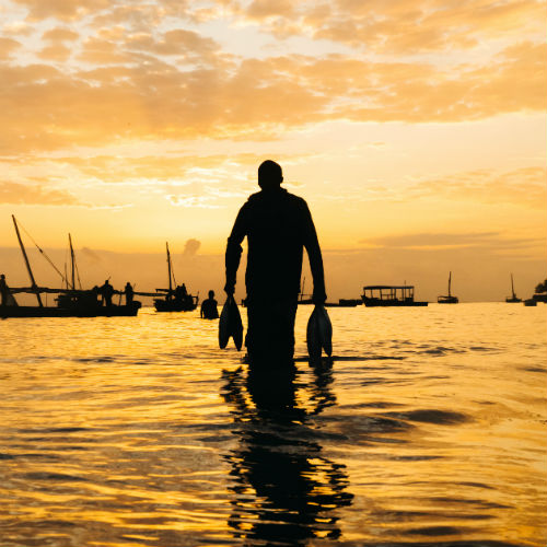 A man carrying his catch from sea