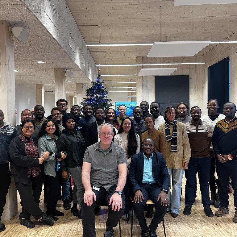 Fellows pose with Dr. Kasozi