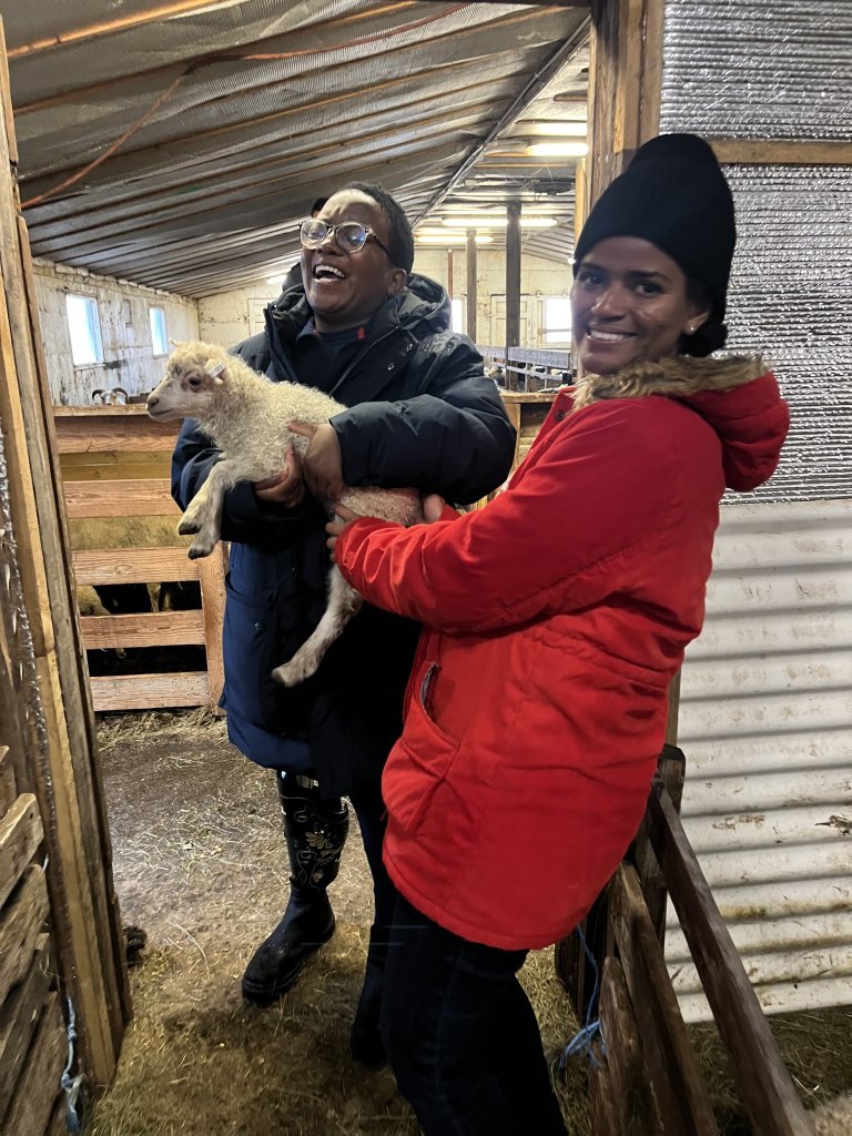 Elizabeth and Rama with a lamb