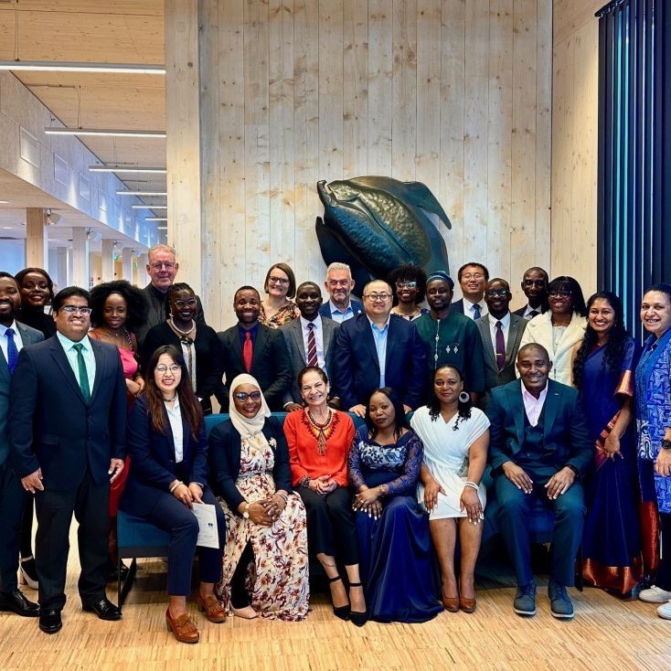Fellows and guests pose for a group photo after the graduation