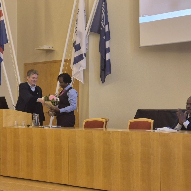 Safina receives flowers after her successful PhD defence.