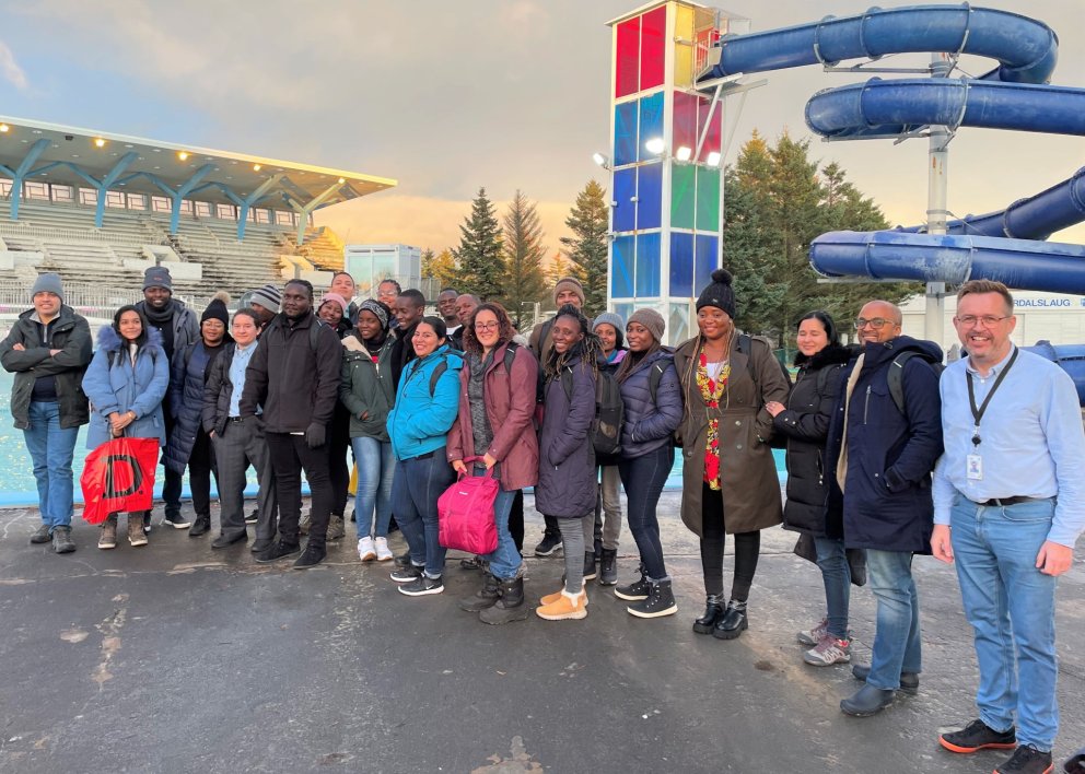 Fellows in front of the main outdoor pool joined by Árni Jónsson on the far right.