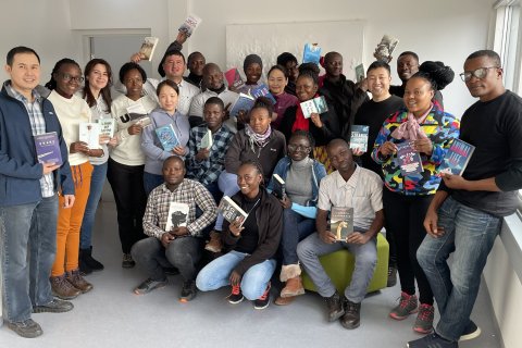 GRÓ LRT fellows with a some of the books donated by Reykjavik UNESCO City of Literature.