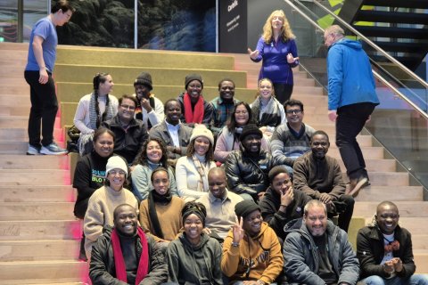 GRÓ FTP fellows and staff pose on the stairs of the visitor´s centre at the Hellisheiði Power Station.