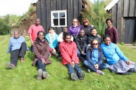 The fellows in front of a traditional turf house