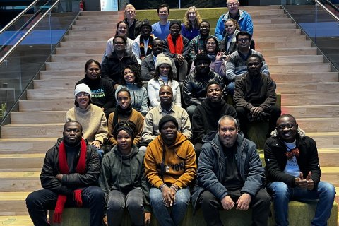 GRÓ FTP fellows and staff pose on the stairs of the visitor´s centre at the Hellisheiði Power Station.